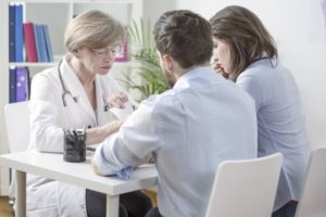 A Gynecologist trying to calm a couple