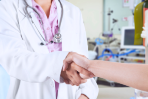 A doctor and patient shaking hands